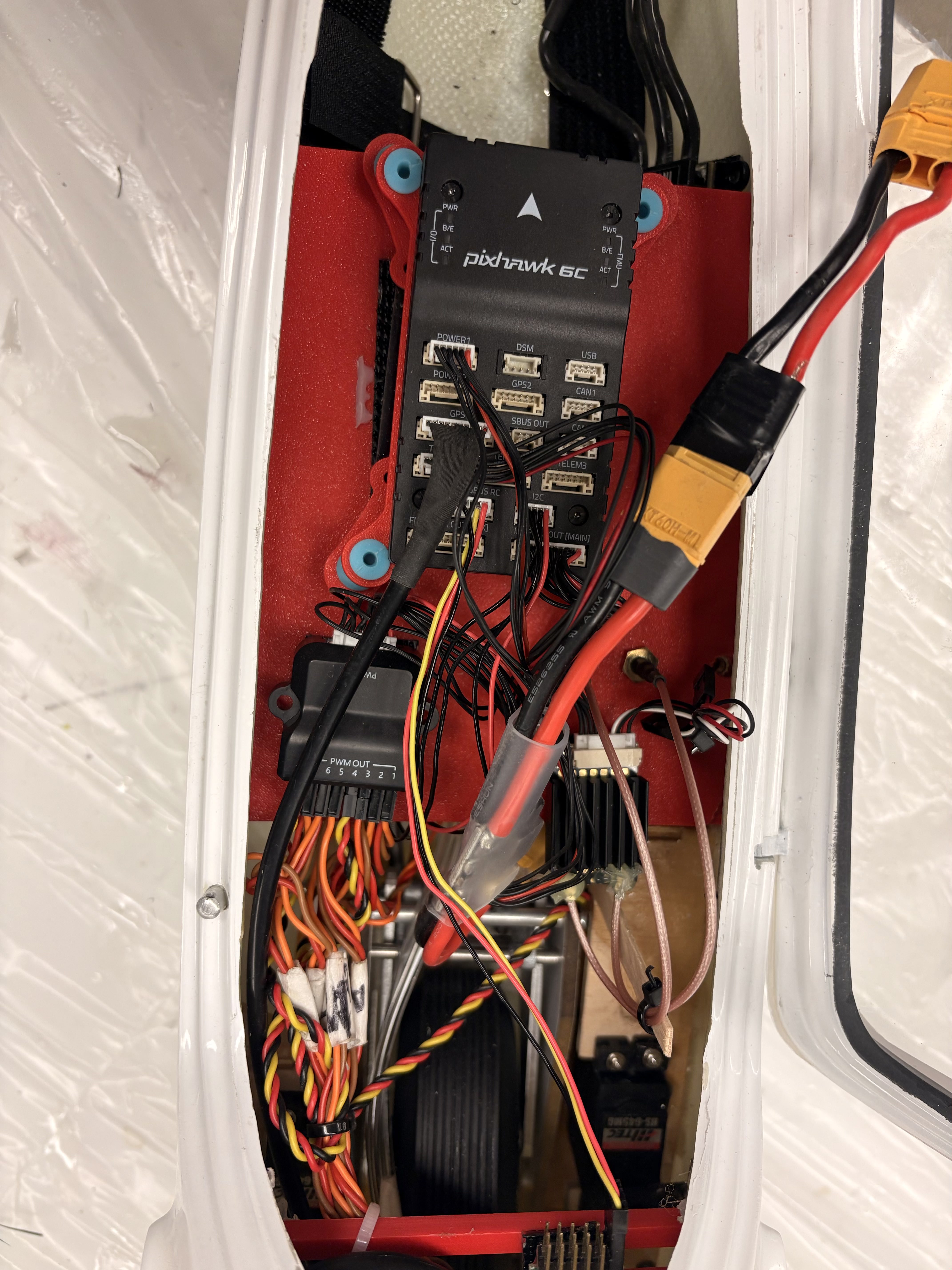 Close-up of the Pixhawk 6C flight controller mounted on the power distribution plate